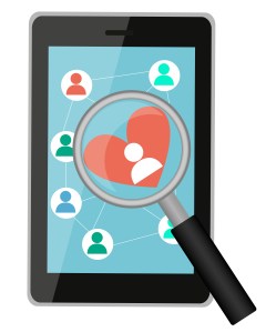 Looking for love online. Tablet with a magnifying glass and hear